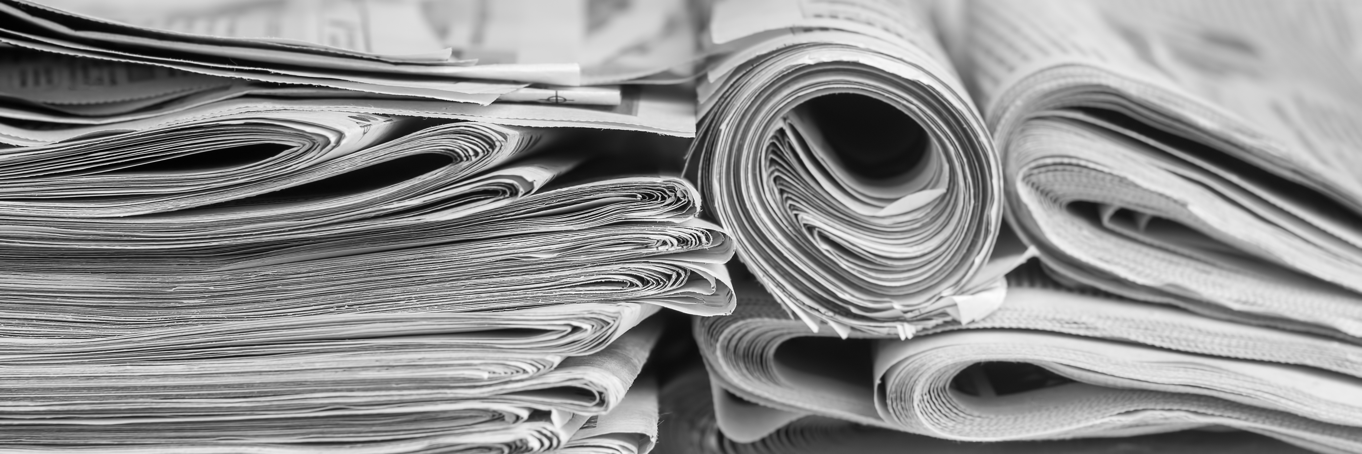 A stack of folded newspapers on the desktop in the office. Lates A stack of folded newspapers on the desktop in the office. Lates