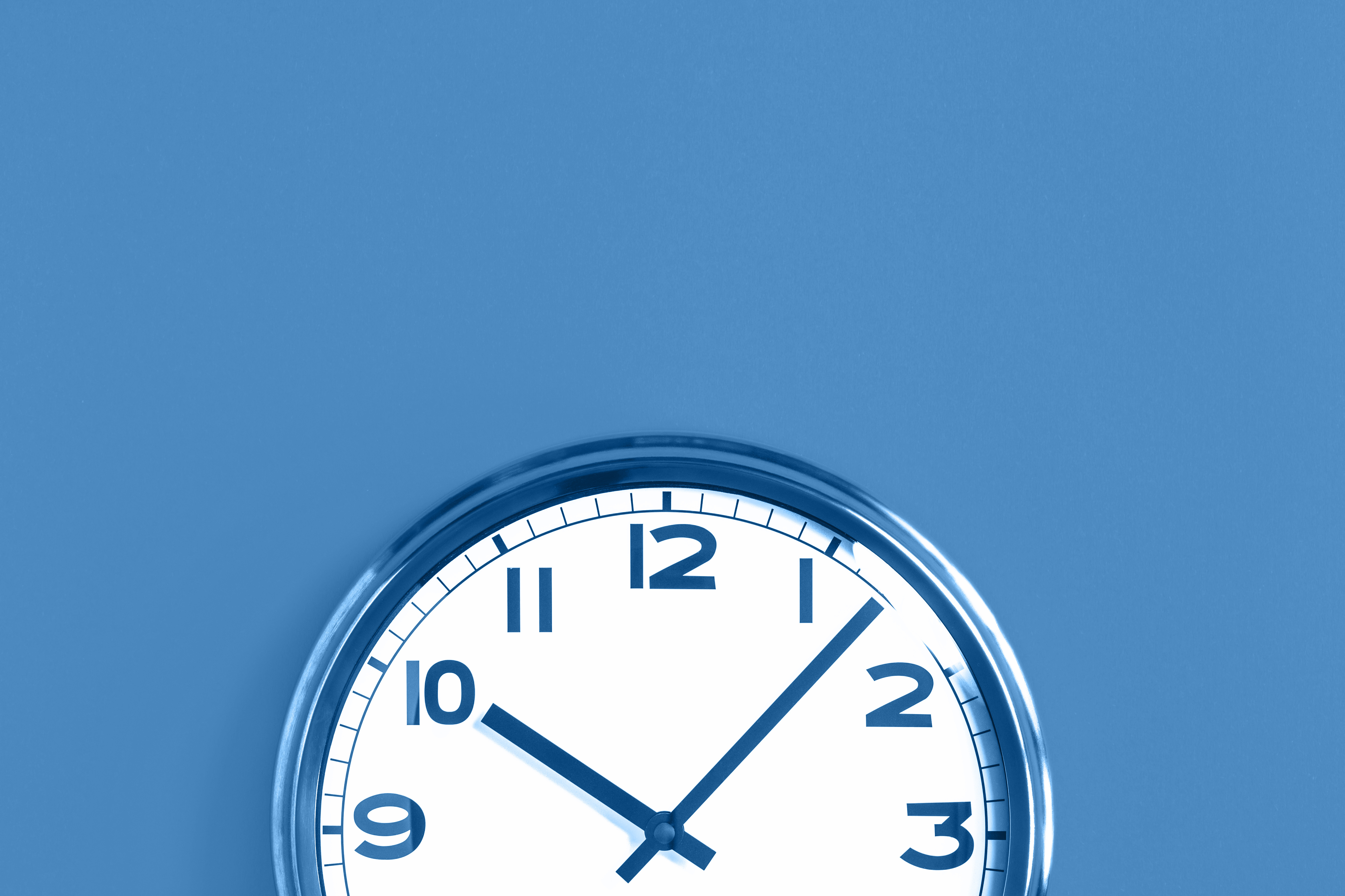 Top half of big wall clock on blue background
