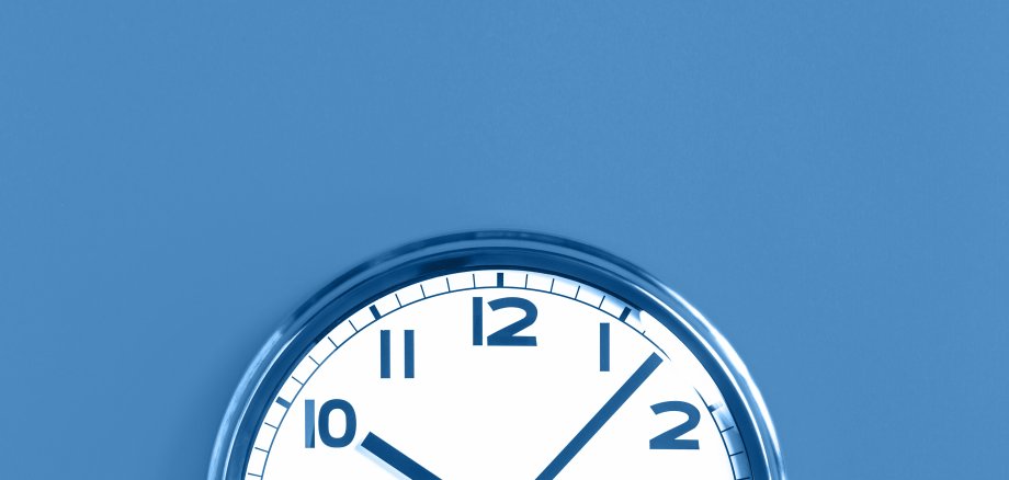 Top half of big wall clock on blue background