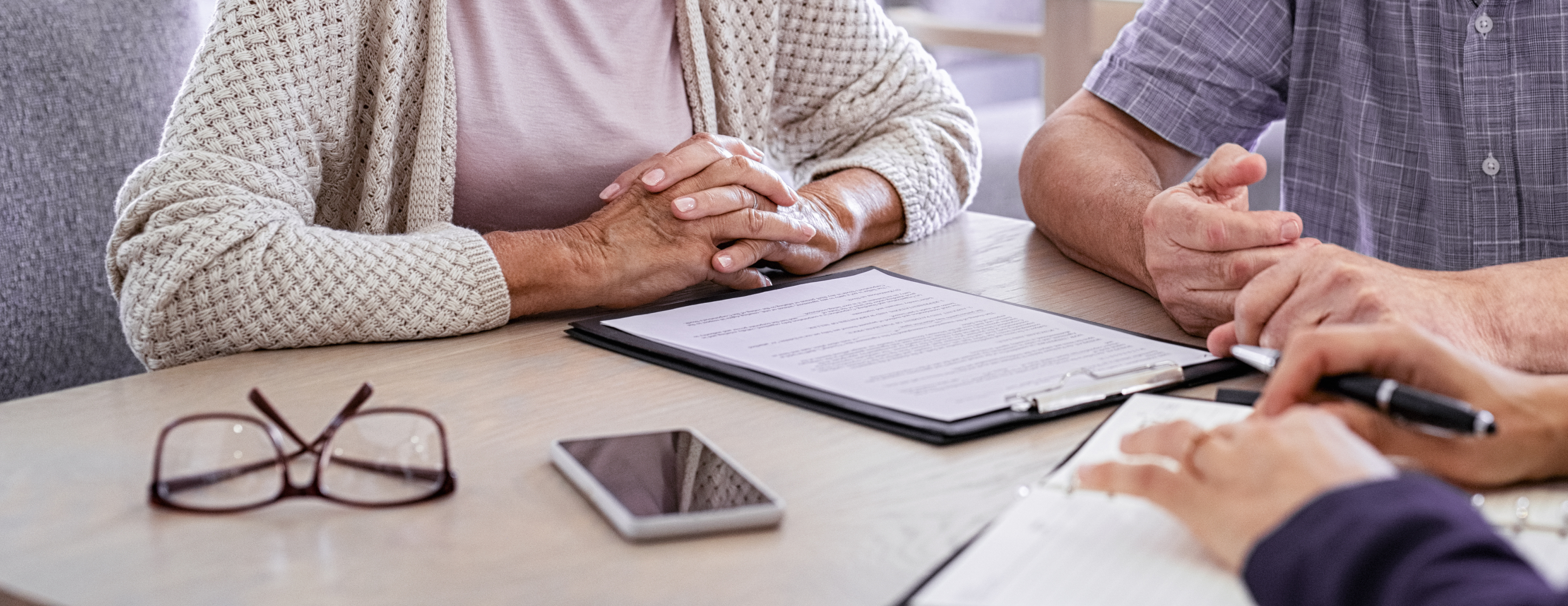 Senior couple planning their investments with financial advisor Senior couple planning their investments with financial advisor